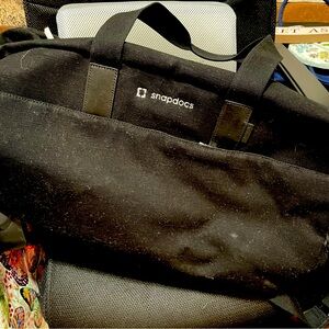 Large Snapdocs black duffle bag with hand or shoulder straps.